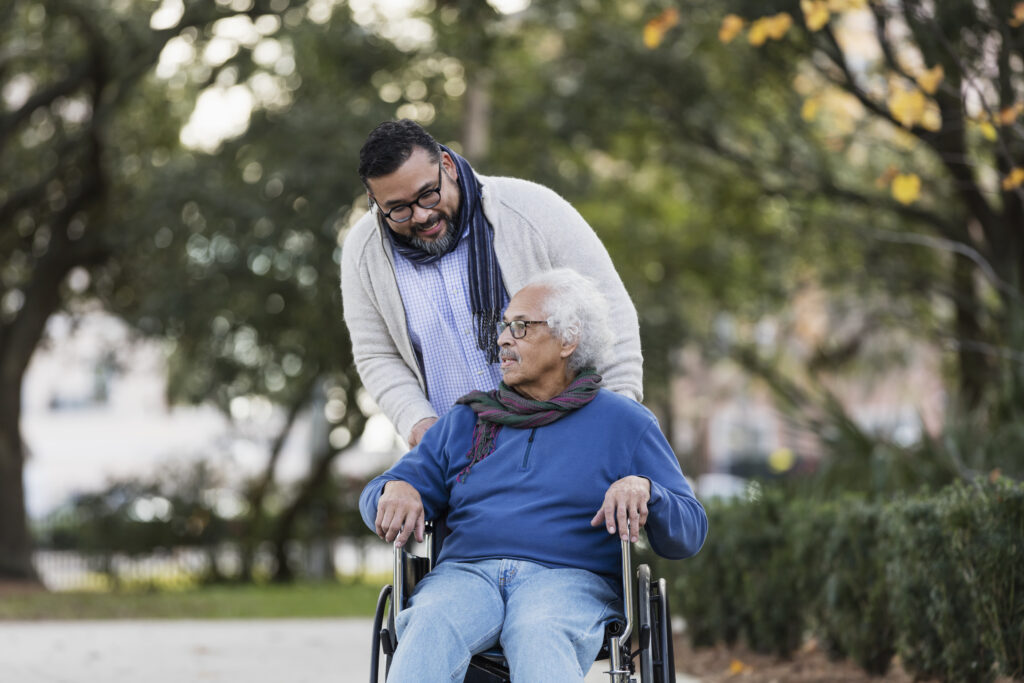 a man pushing a senior in a wheelchair