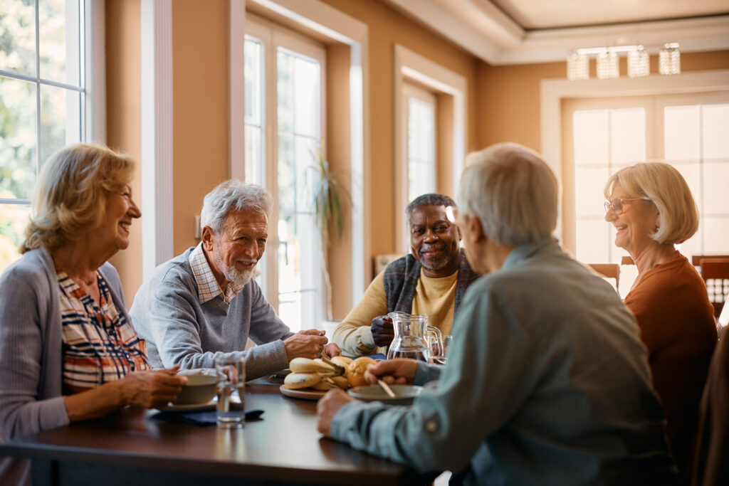 Seniors smiling over breakfast table
